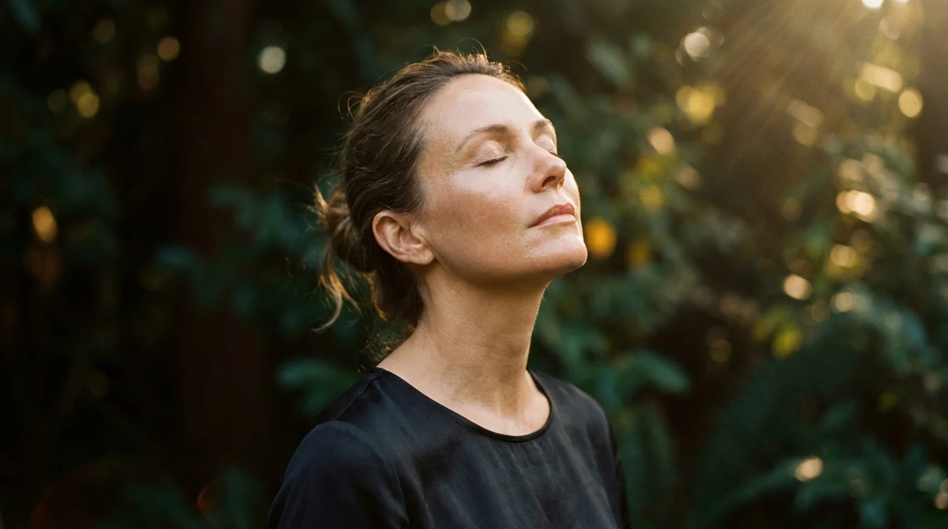 A woman with radiant, healthy skin in warm natural light